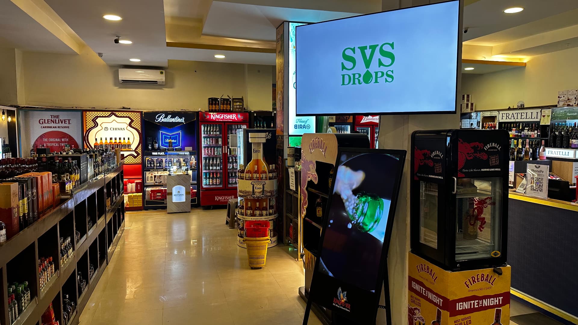 A digital advertising screen at SVS Drops